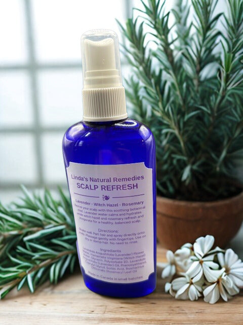 Scalp Refresh Cooling Mist in a blue spray bottle, featuring peppermint and rosemary essential oils by Lindaโs Natural Remedies.