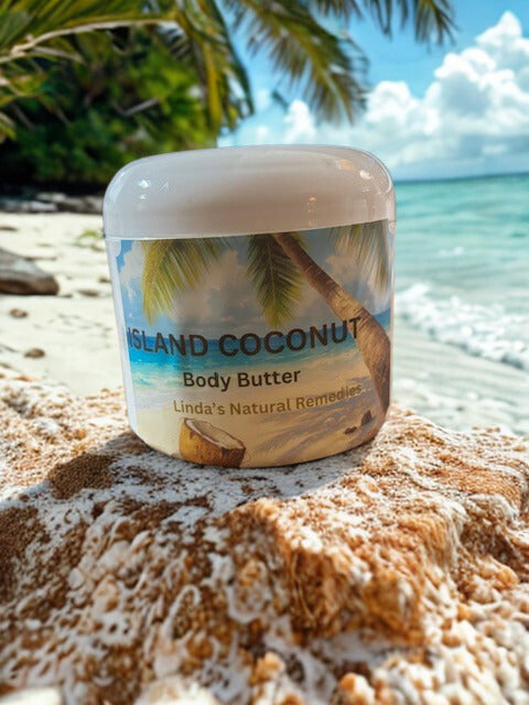 A jar of Island Coconut Emulsified Body Butter sitting on a white sand dune. In the background, a tropical palm tree leans over a crystal-clear blue ocean under a bright sky, perfectly capturing the lush, tropical escape of the scent.