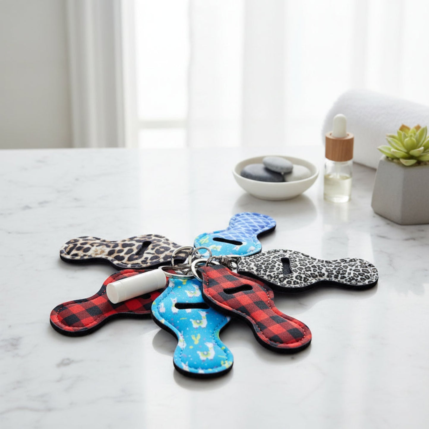 "A selection of patterned lip balm holders, including leopard print and plaid, representing the surprise variety for the Dealer's Choice option."