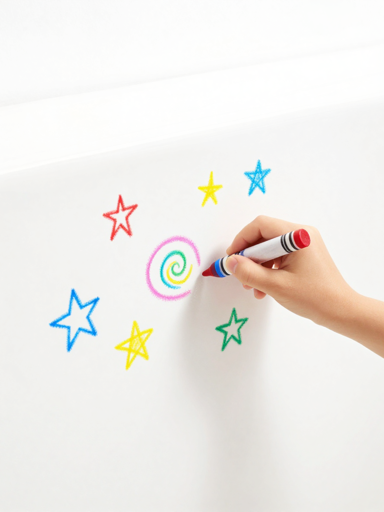 Little hand showing how the bath crayons will work on tub surface.