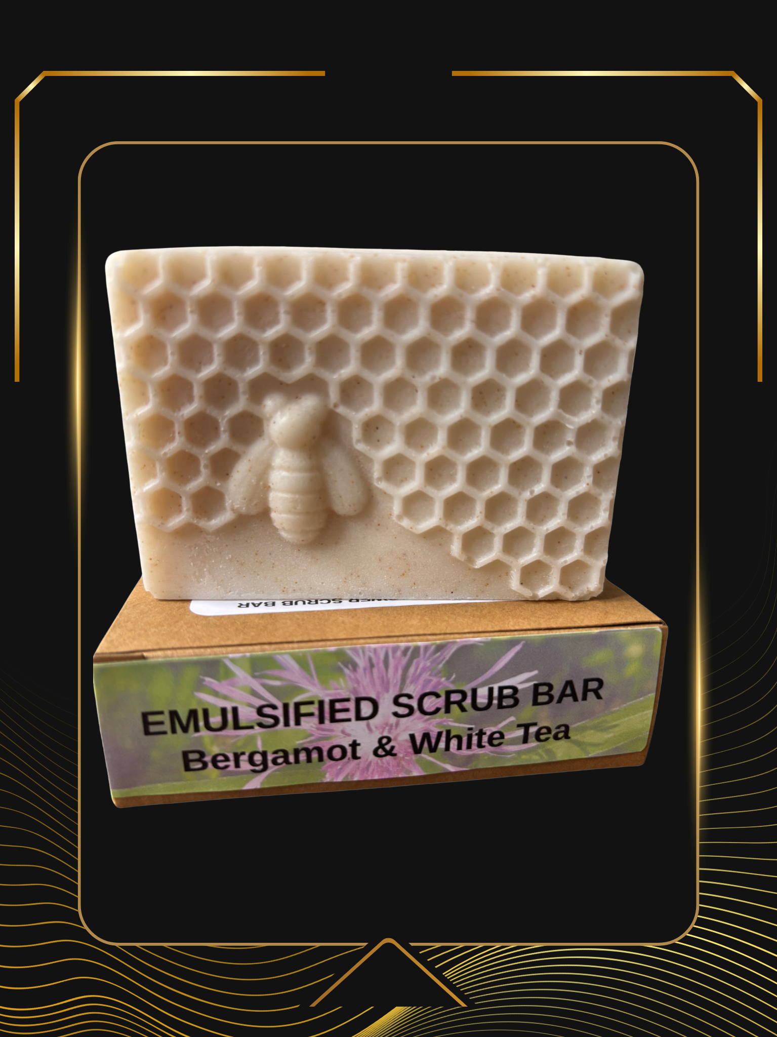 Bergamot and White Tea Emulsified Scrub Bar with a honeycomb and bee texture, sitting on its packaging against a black and gold background by Linda's Natural Remedies.