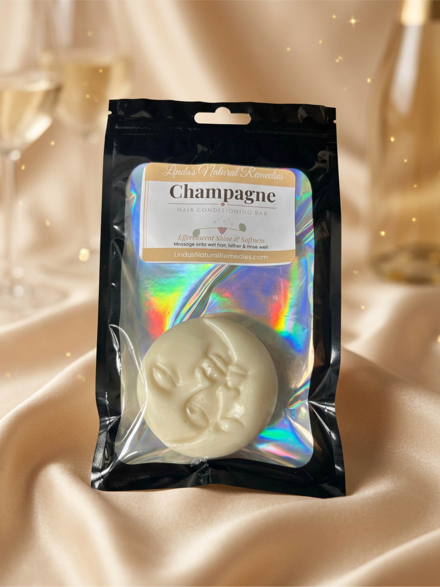 Soap bar in a packaging labeled 'Champagne' on a beige fabric background