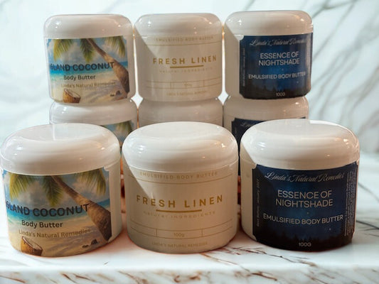Collection of body butter jars with various scents on a marble surface