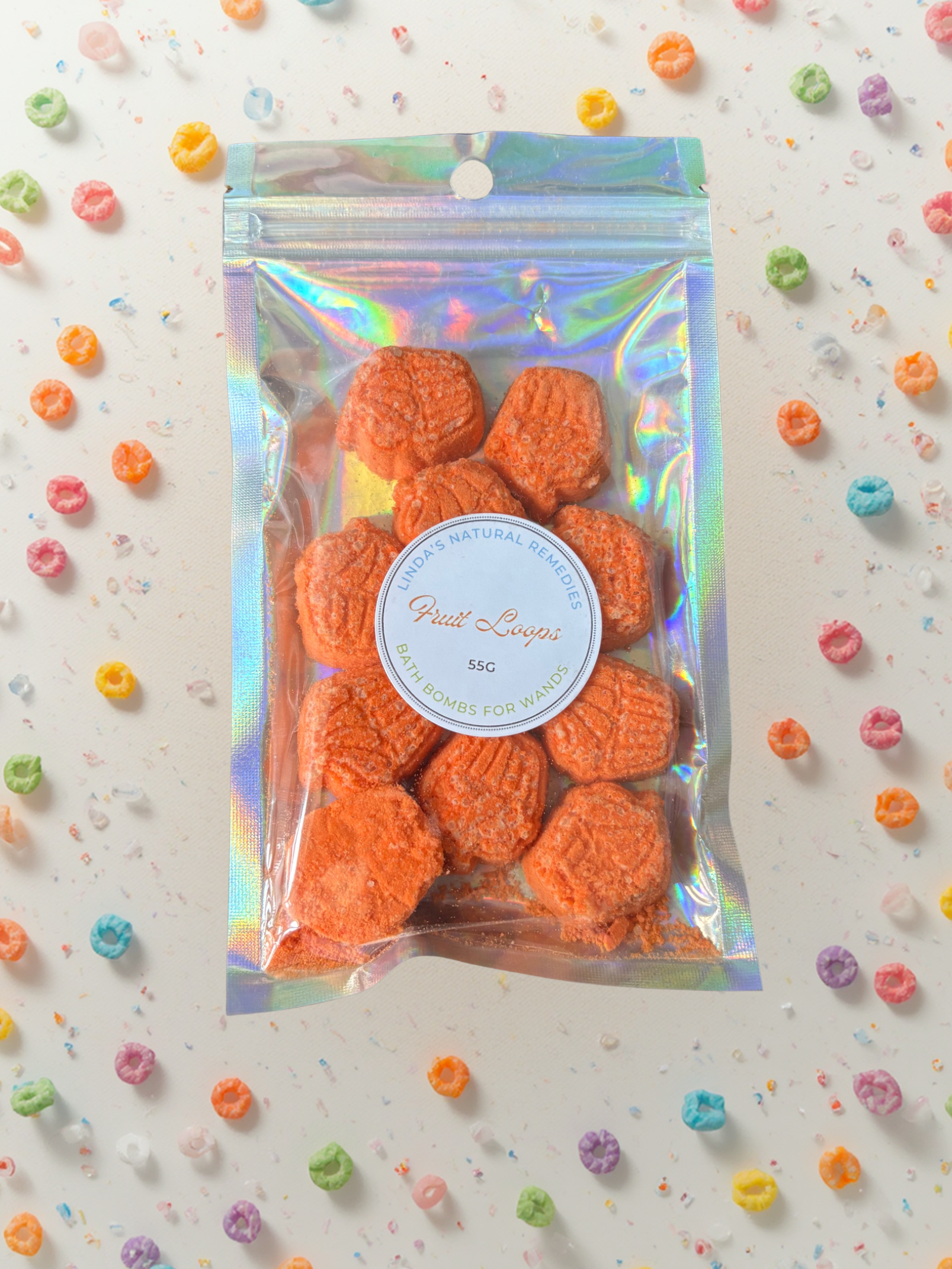 Fruit Loops scented orange cup bakes surrounded by fruit loops.