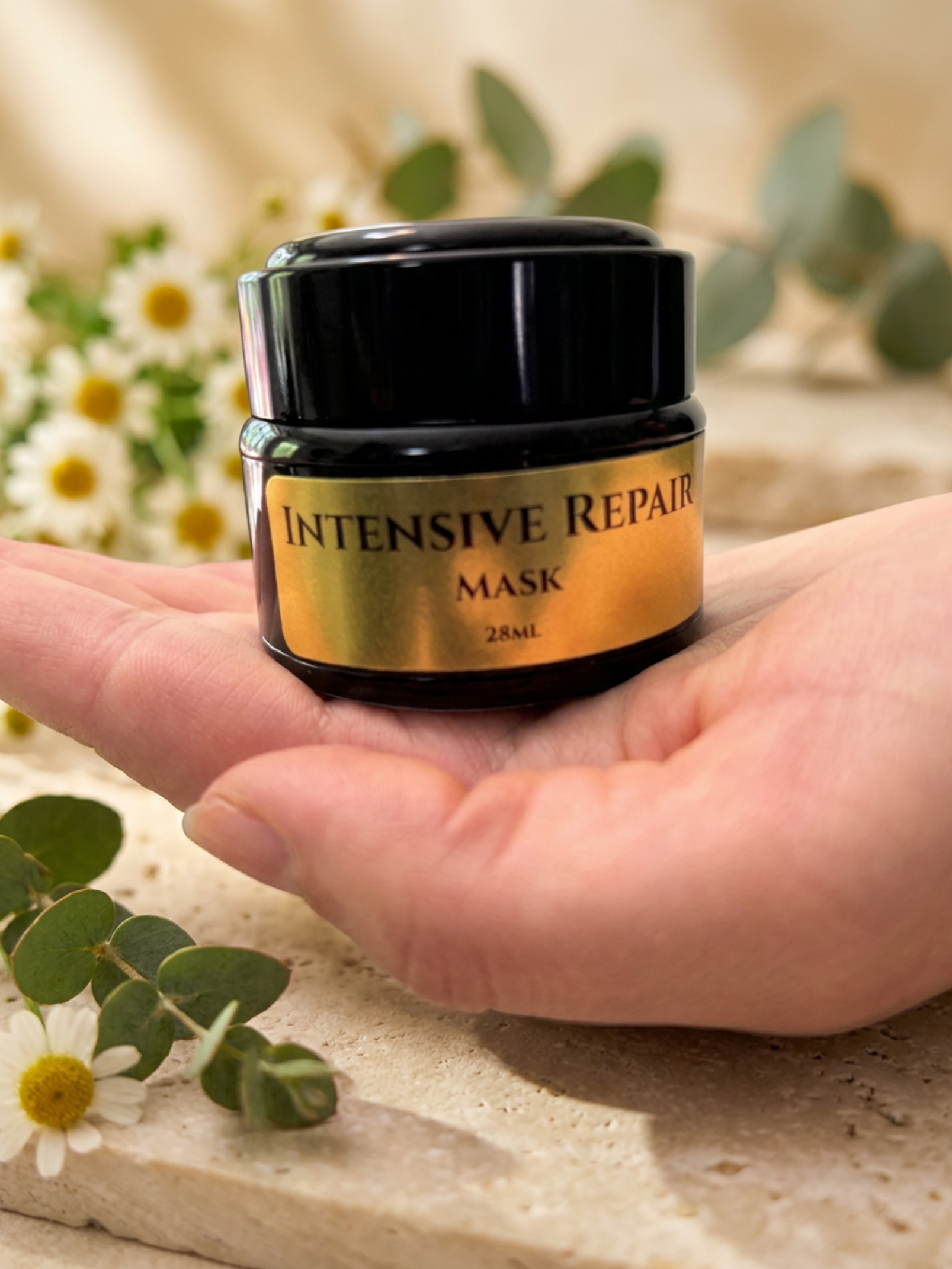 Intensive Repair Mask jar held in a hand with a natural background