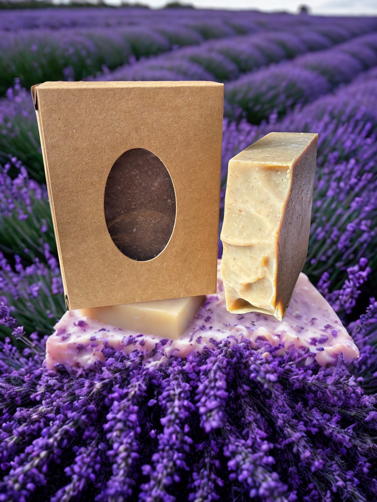 Bar of soap with a brown packaging box on a bed of lavender flowers