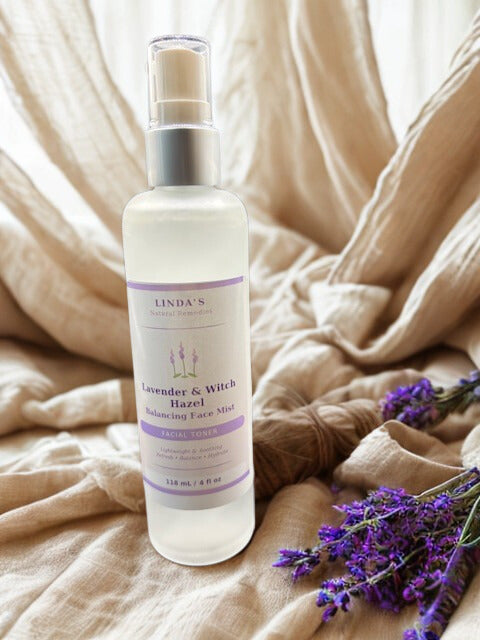 A clear glass bottle of Lavender & Witch Hazel Balancing Face Mist featuring a fine mist sprayer and a glossy label.
