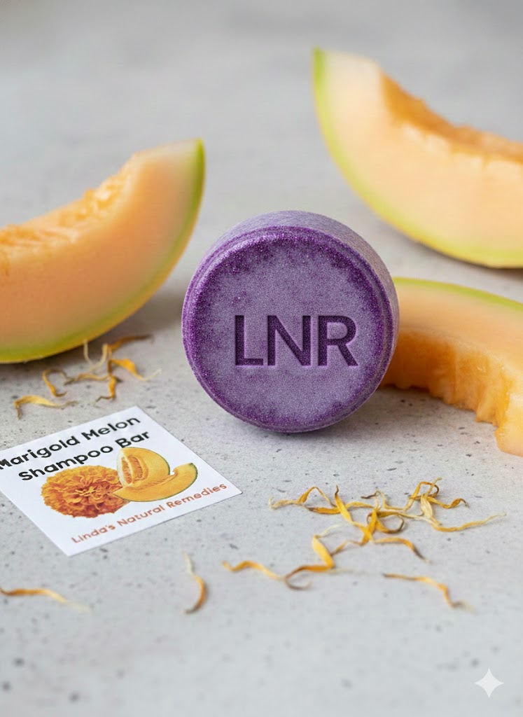 Round solid shampoo bar embossed with LNR, shown with fresh cantaloupe slices and dried marigold petals.