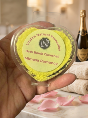 Bath bomb in a clear container with 'Linda's Natural Remedies' branding, held by a hand with a blurred background.