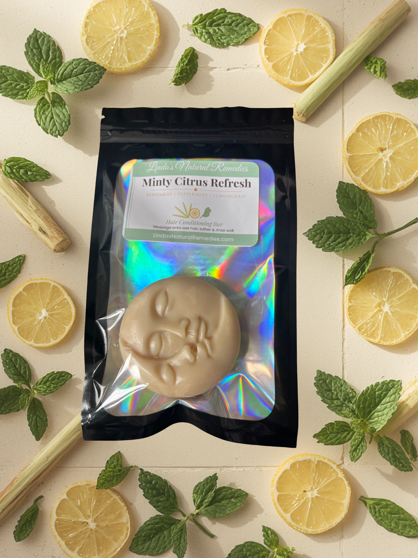 Bar of soap in packaging with lemons and mint leaves on a light background