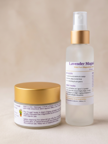 Lavender Magnolia body care set featuring a frosted glass spray bottle with a gold pump collar and a small white jar with a gold lid, both with white labels, set against a neutral beige background.
