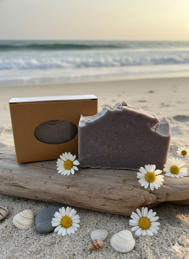 Soap on a beach setting with daisies.