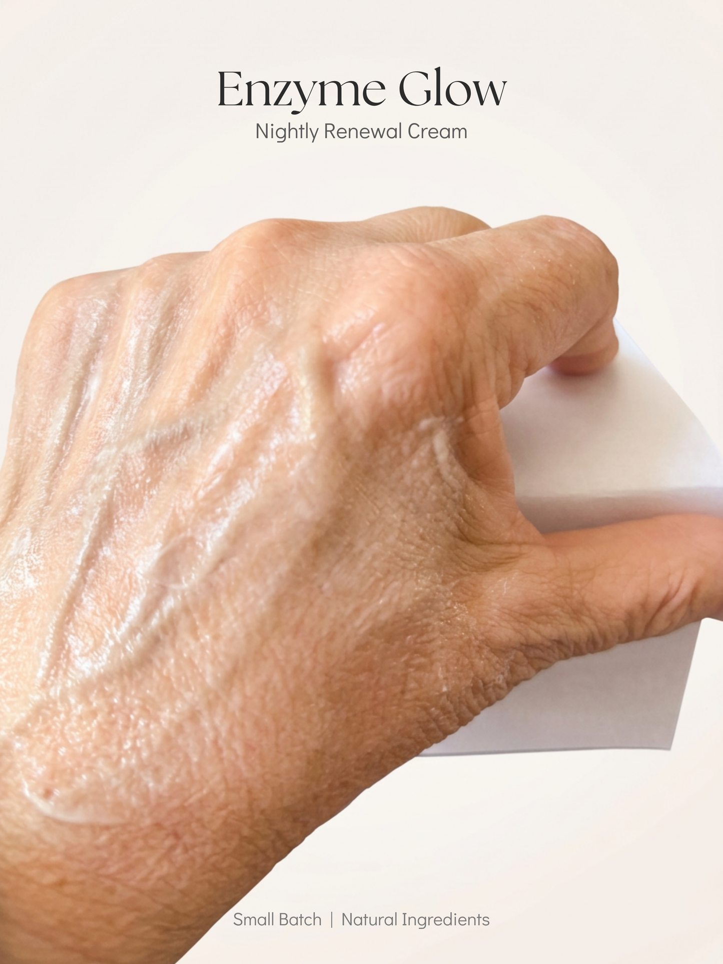 Hand applying cream with 'Enzyme Glow' text on a white background