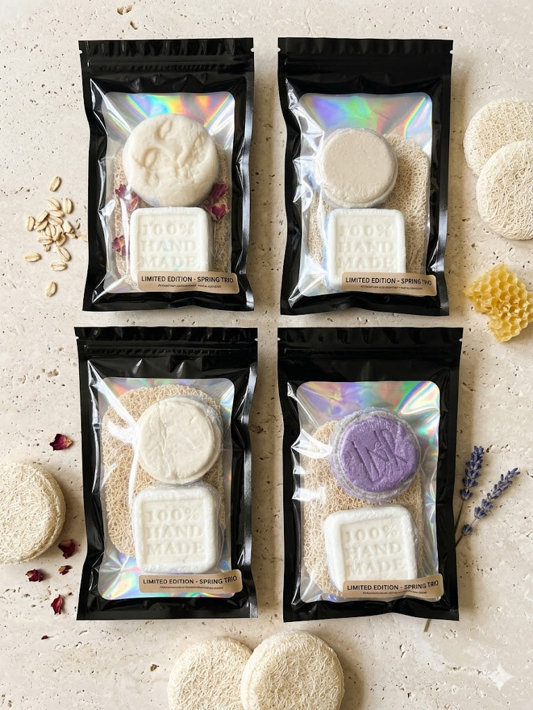 Four packages of soap with visible branding on a light background