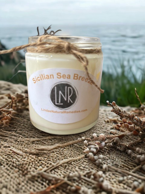 A hand-poured Sicilian Sea Breeze soy candle in a glass jar with a matte label, featuring a clean cotton wick and natural soy wax.