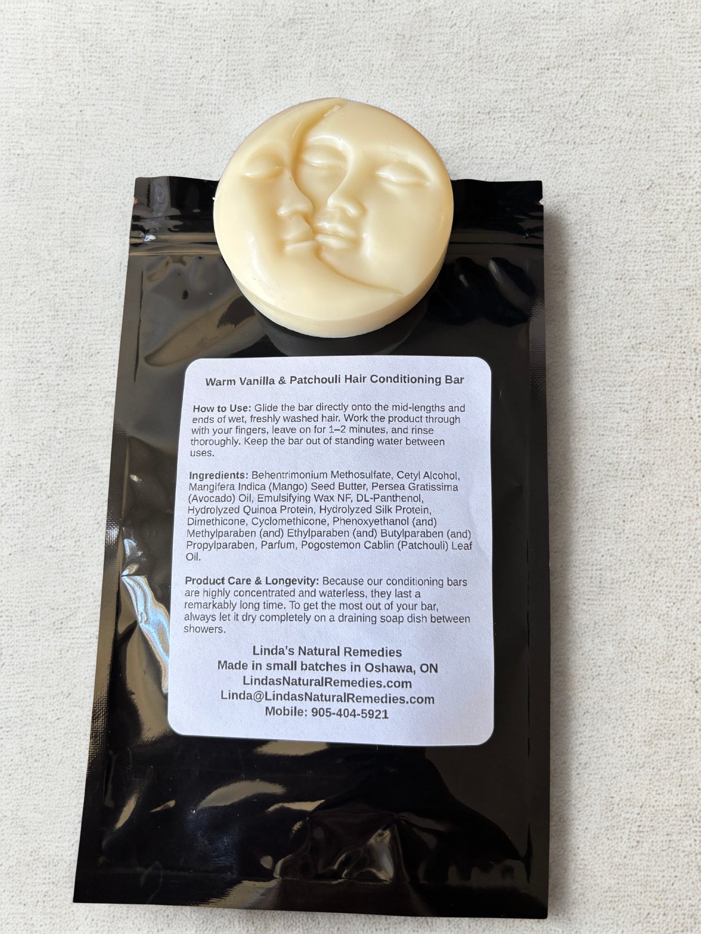 Hair conditioning bar with packaging on a textured surface
