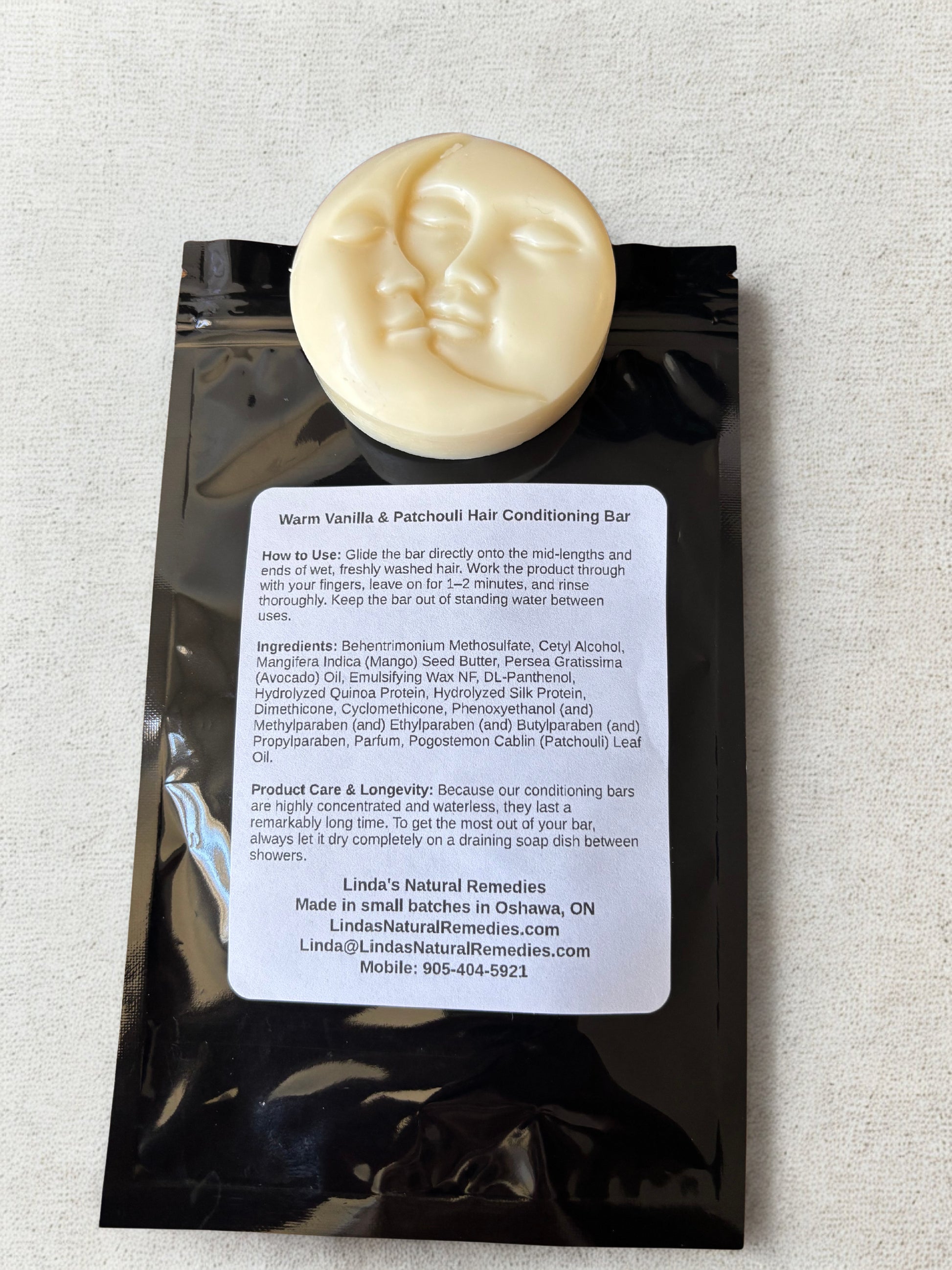 Hair conditioning bar with packaging on a textured surface