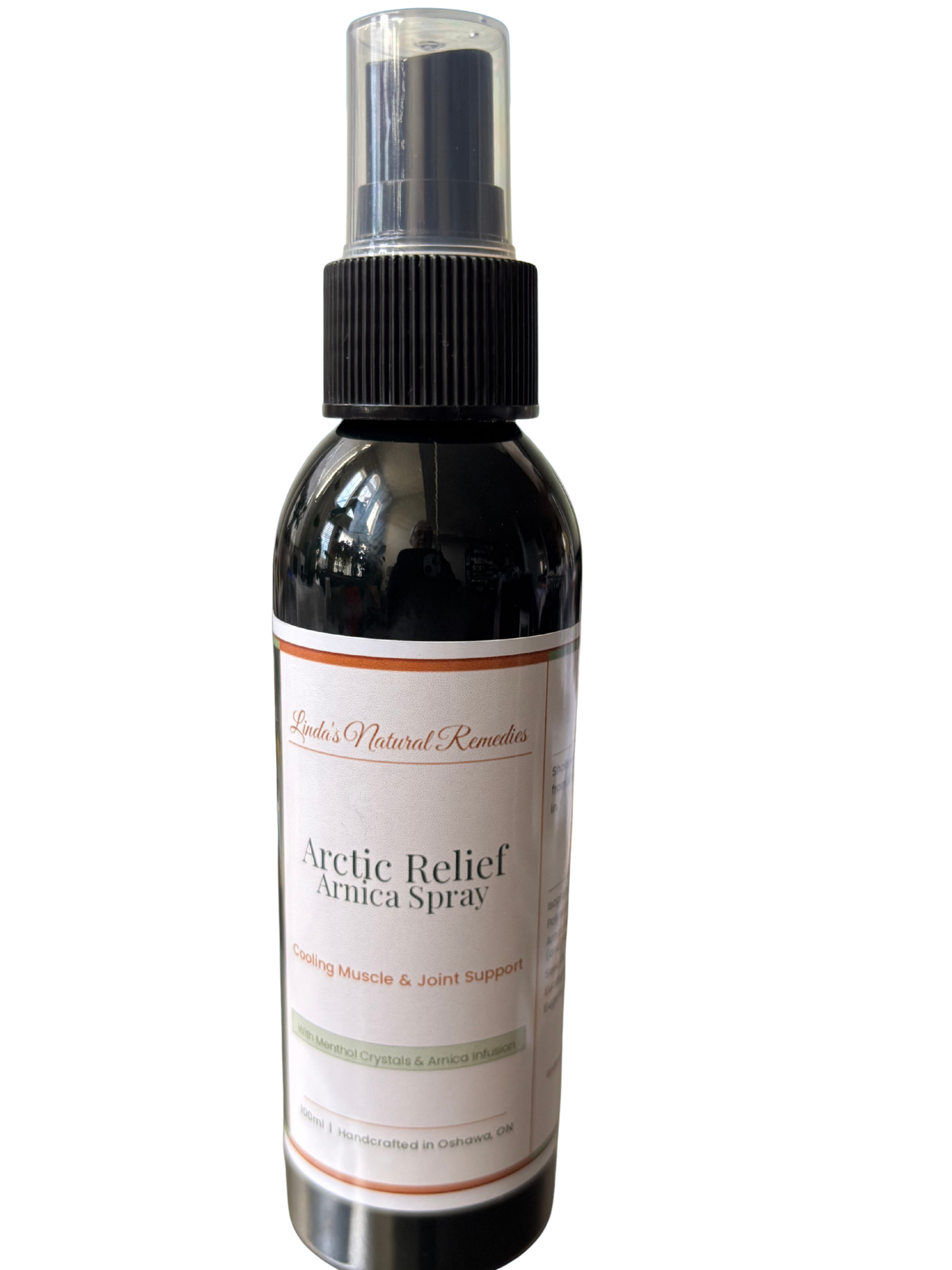 Arctic Relief Arnica Spray by Linda's Natural Remedies in a 100ml black bottle with a copper and sage green label. This cooling topical spray is handcrafted in Oshawa for muscle and joint support.